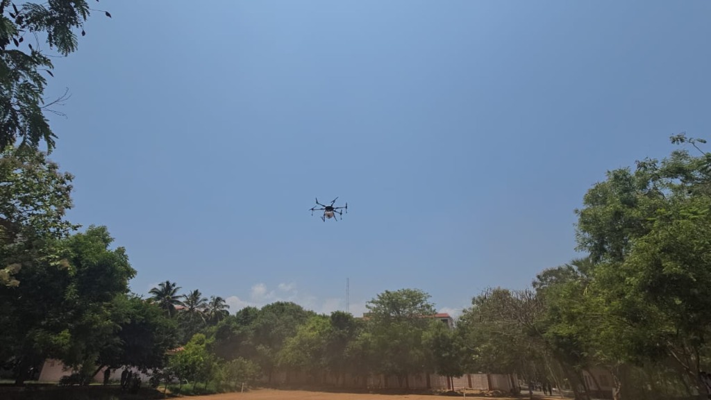 Agricultural drone spraying crops in the sky