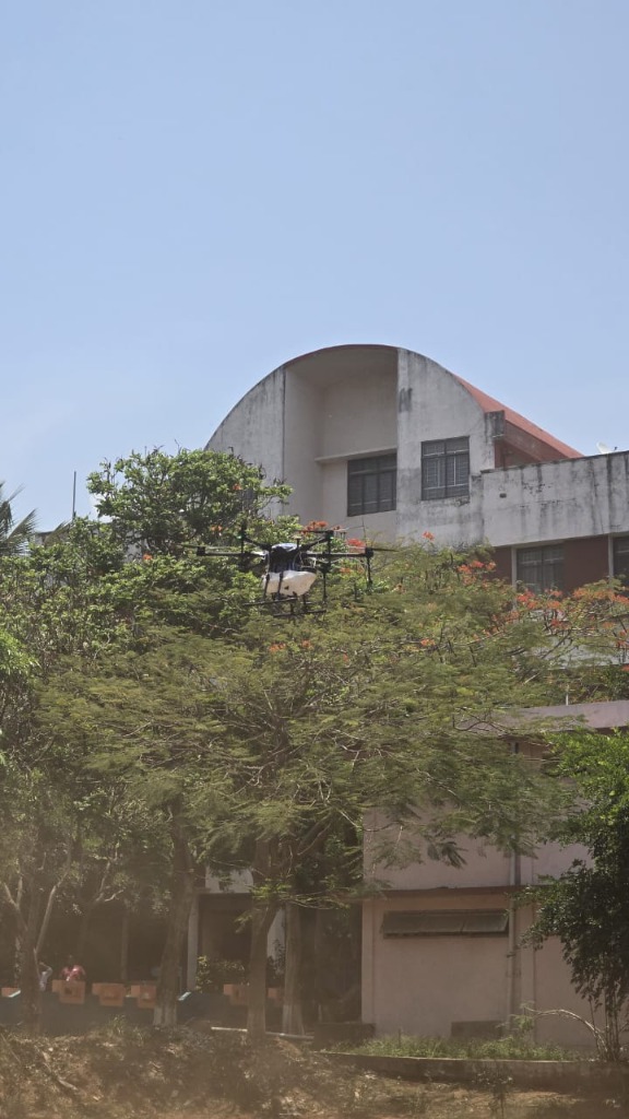 Quadcopter drone mapping crops near trees